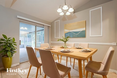 A dining room with a wooden table and chairs.
