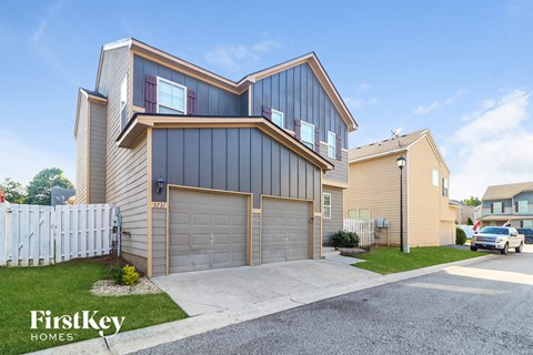 a street view of a house with two garage doors