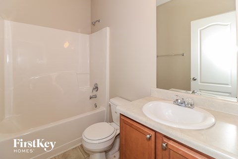 a bathroom with a sink toilet and a tub
