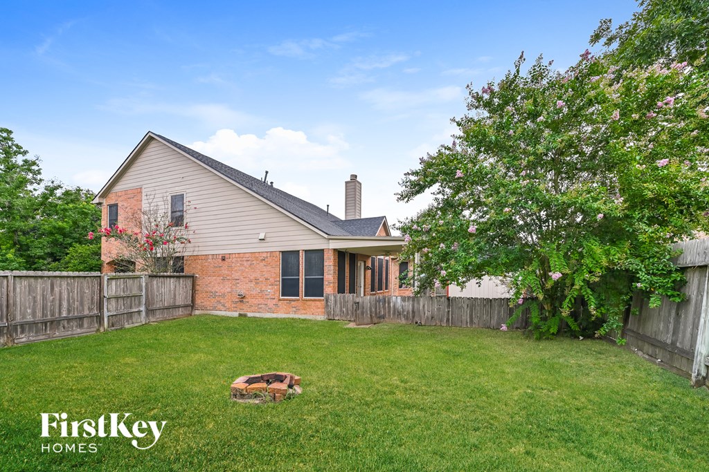 a backyard with a fence and a house