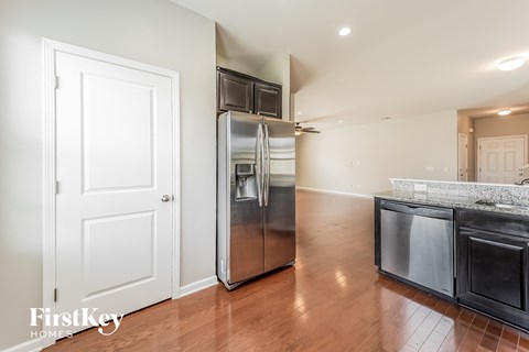 A kitchen with a stainless steel refrigerator and oven.