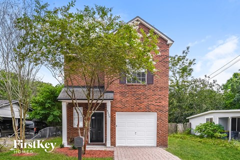 a brick house with a white garage door