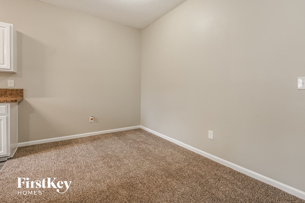 a bedroom with a carpeted floor and white walls