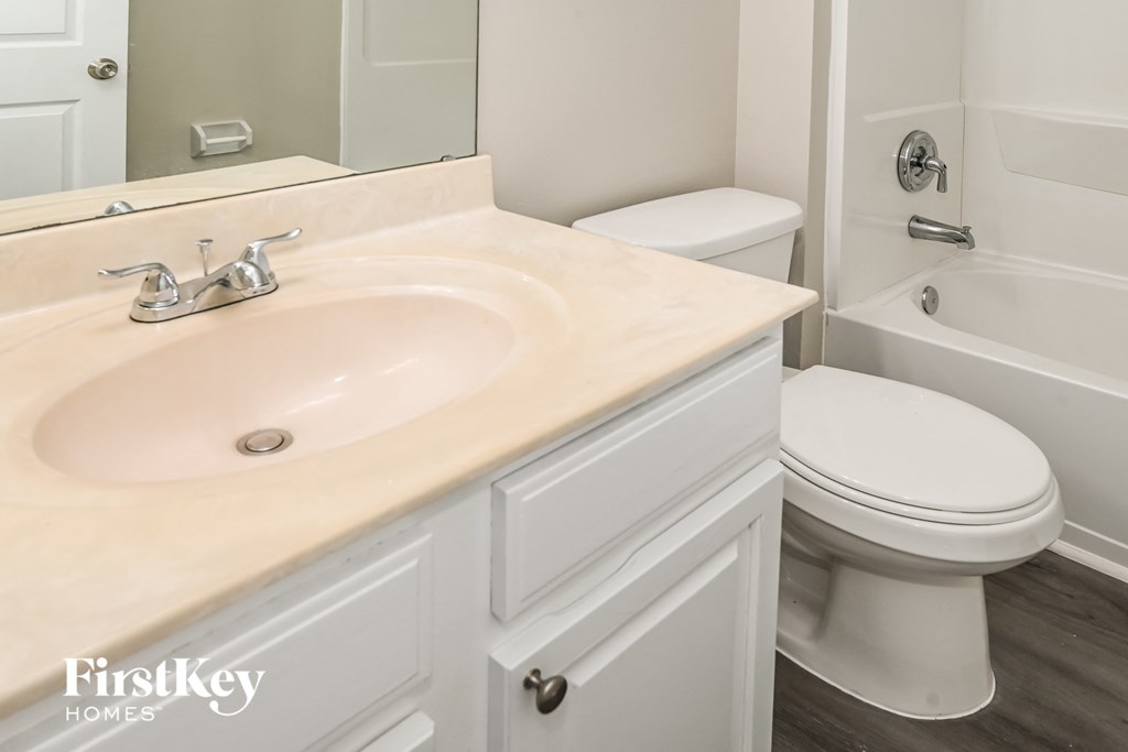 a white bathroom with a sink and a toilet