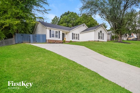 a white house with a sidewalk in front of it