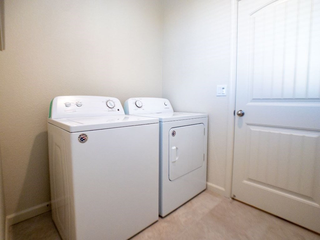 a washer and dryer in a laundry room with a door