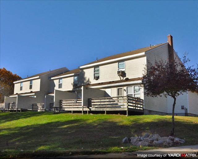 a large house with a tree in front of it