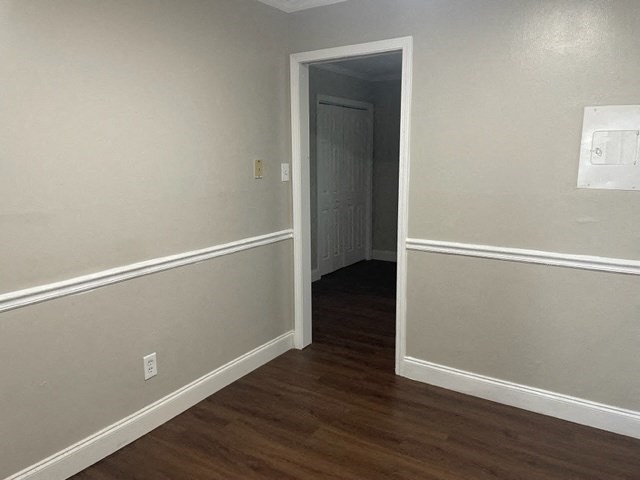 an empty room with a door to a hallway