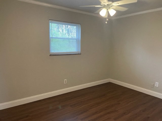 an empty room with a ceiling fan and a window