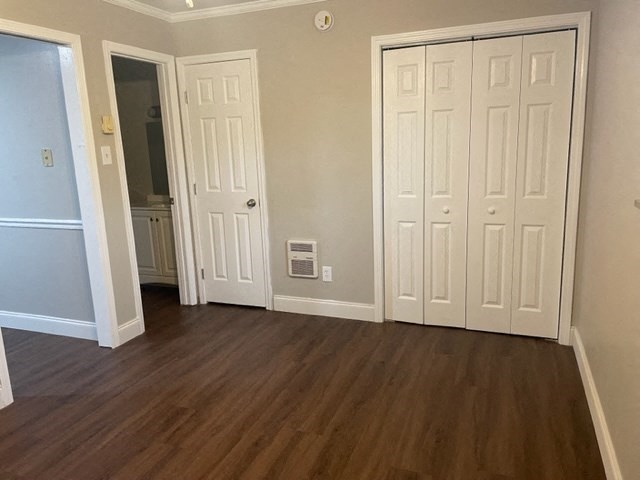 a living room with wooden floors and white doors