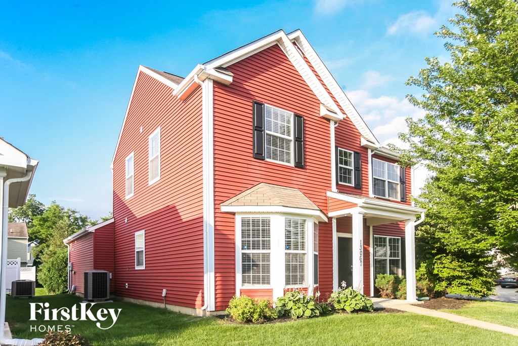 a red house with white trim and black shutters