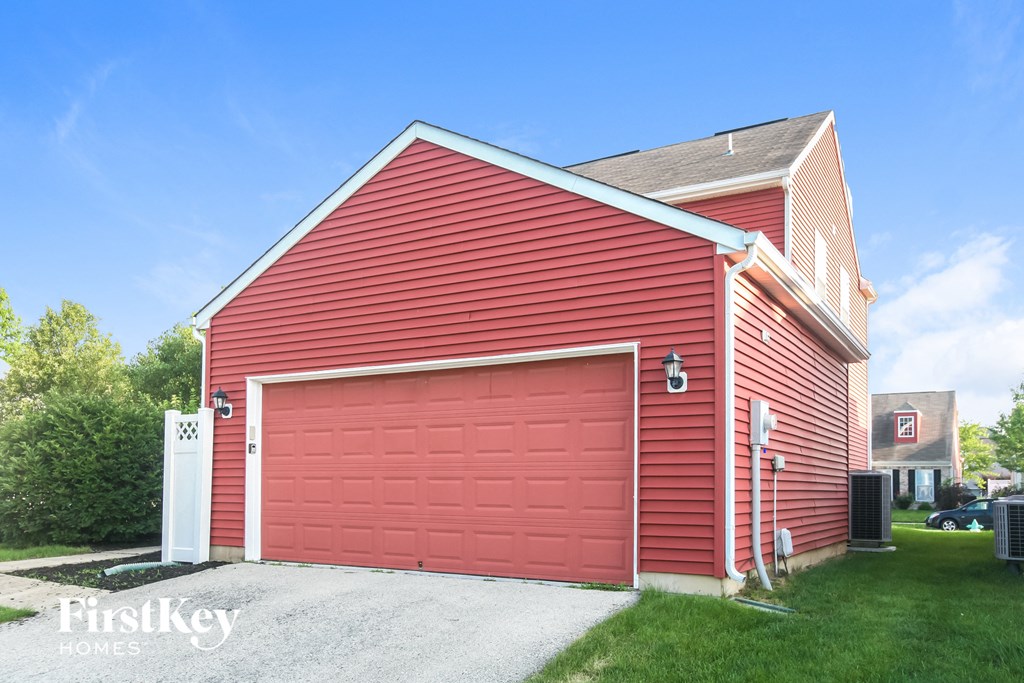 a red barn with a red garage door