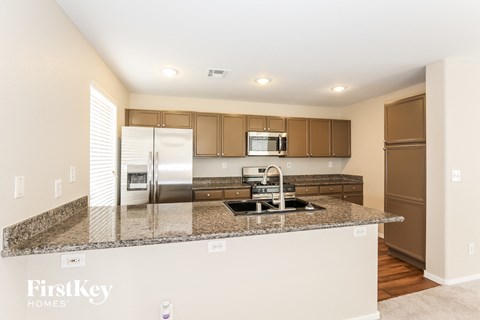 a kitchen with granite counter tops and stainless steel appliances