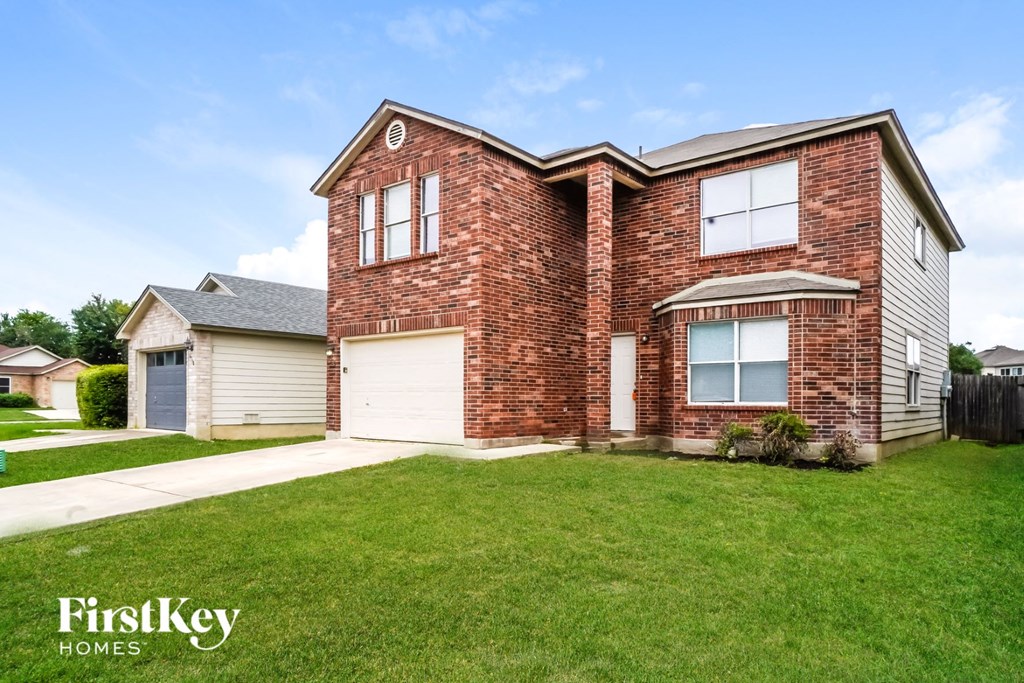 A brick house with a garage and a window.