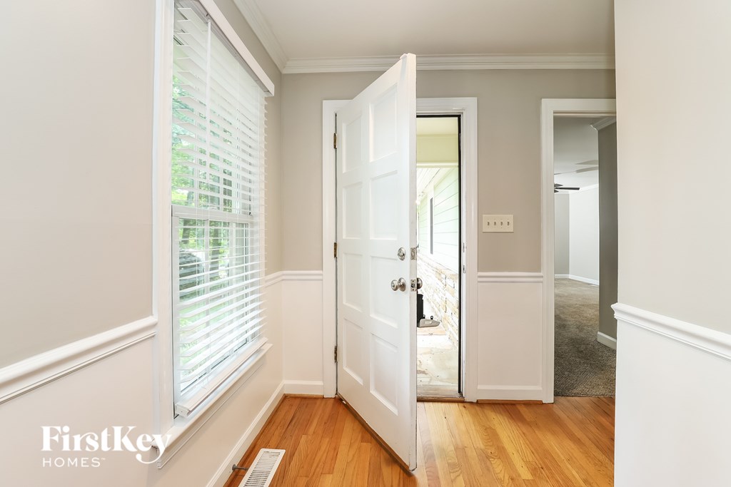 A white door is open to a hallway.