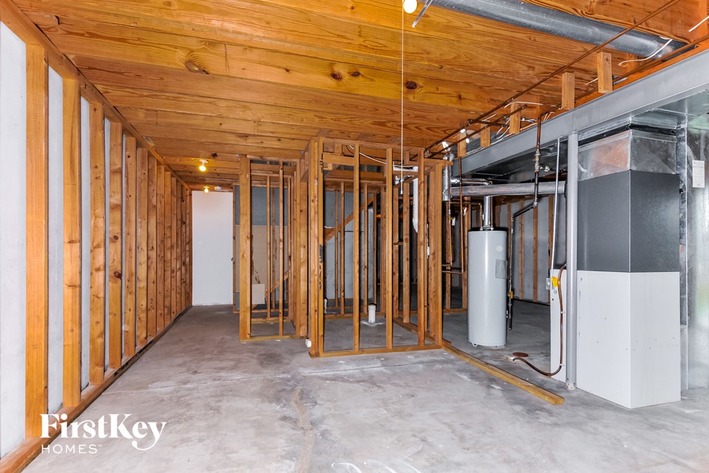 a house under construction with wood studs and walls and a refrigerator