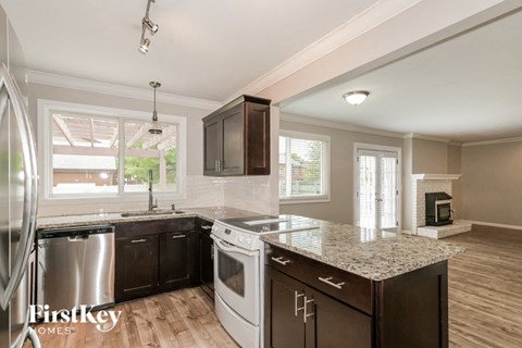 a kitchen with an island and a stove and a sink