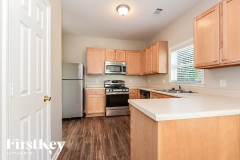 A kitchen with wooden cabinets and a white countertop.