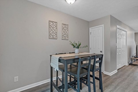 a dining room with a table and chairs