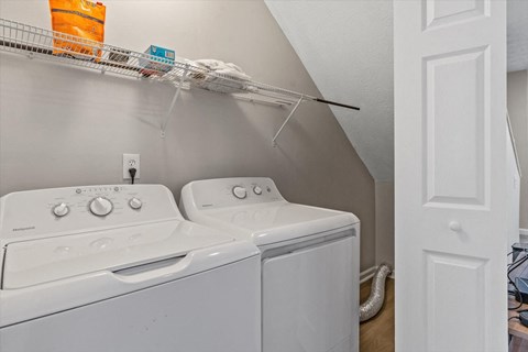 the washer and dryer in the laundry room of a home with a roof
