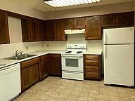 a kitchen with a stove refrigerator and a sink