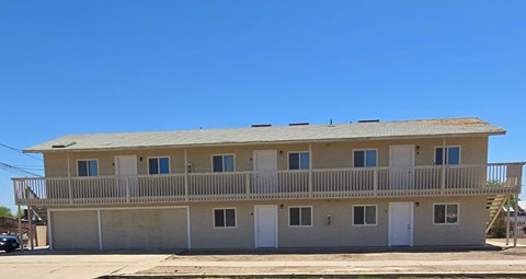 A two-story building with a balcony on the second floor.