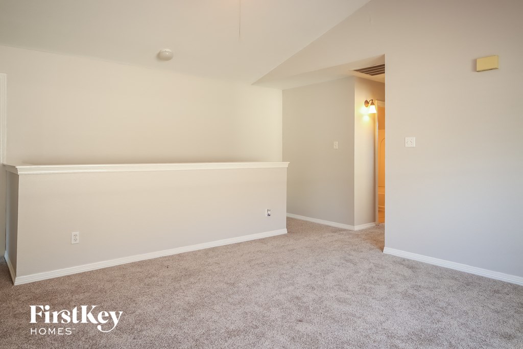 a room with a white wall and a carpeted floor