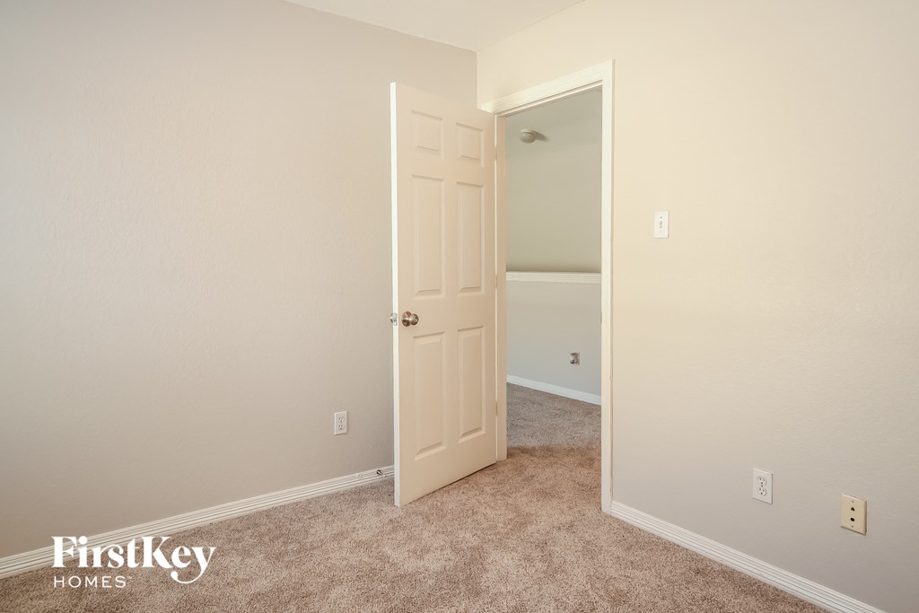 a bedroom with a closet and an open door