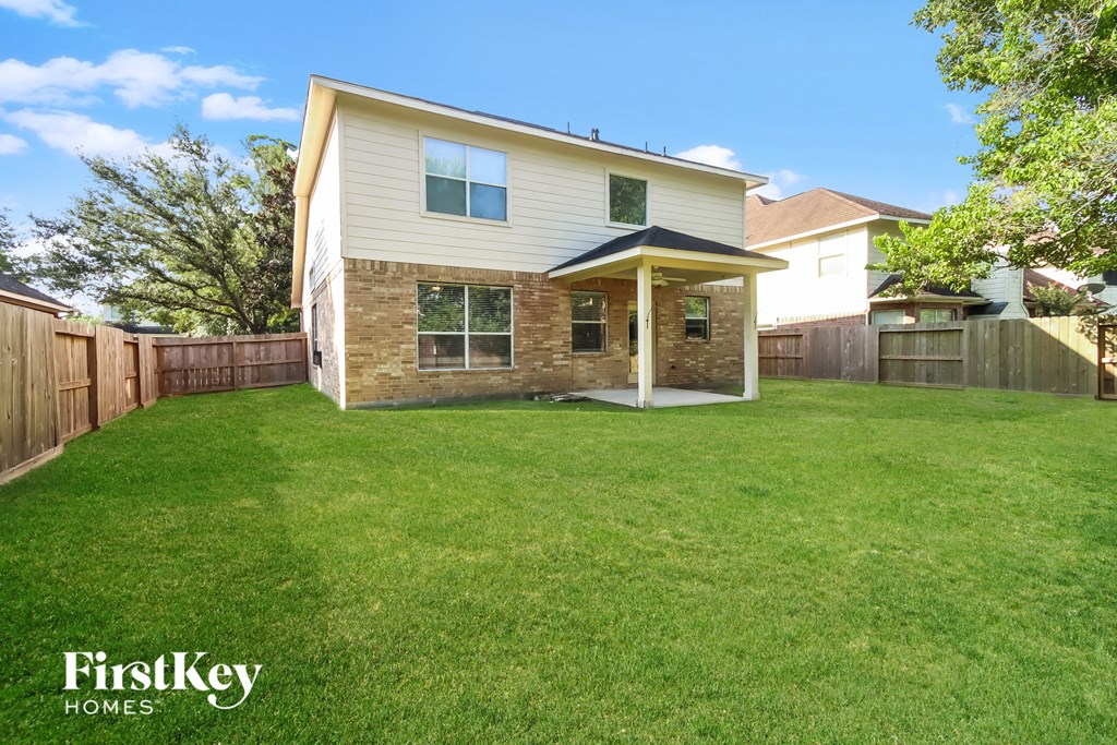a backyard with a lawn and a house