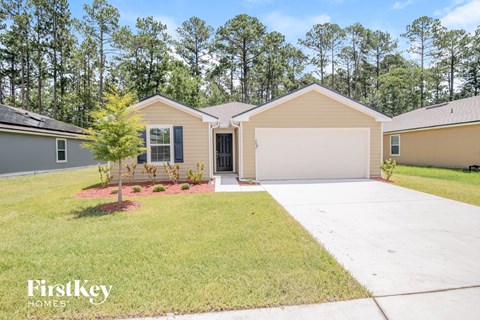 a beige house with a driveway and a garage door