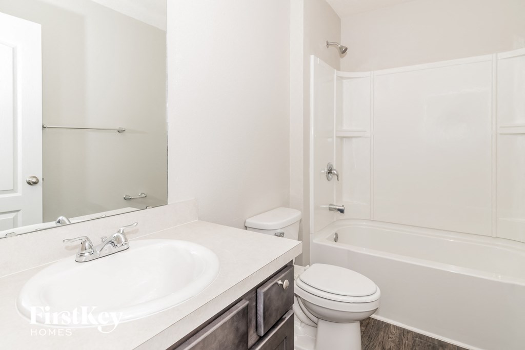 a bathroom with a sink toilet and a bath tub