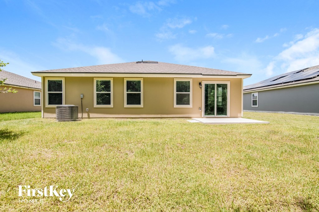 a home with a yard and a house next to it