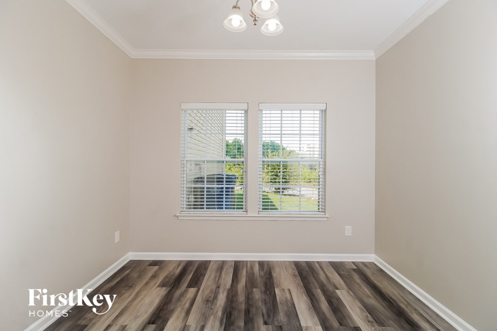 the living room of a house with wood floors and a window