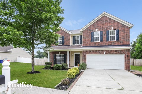 a large brick house with a white garage door