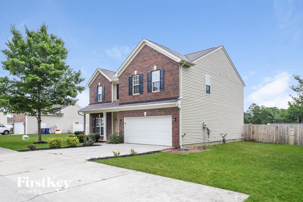 a home with a white garage door and a lawn