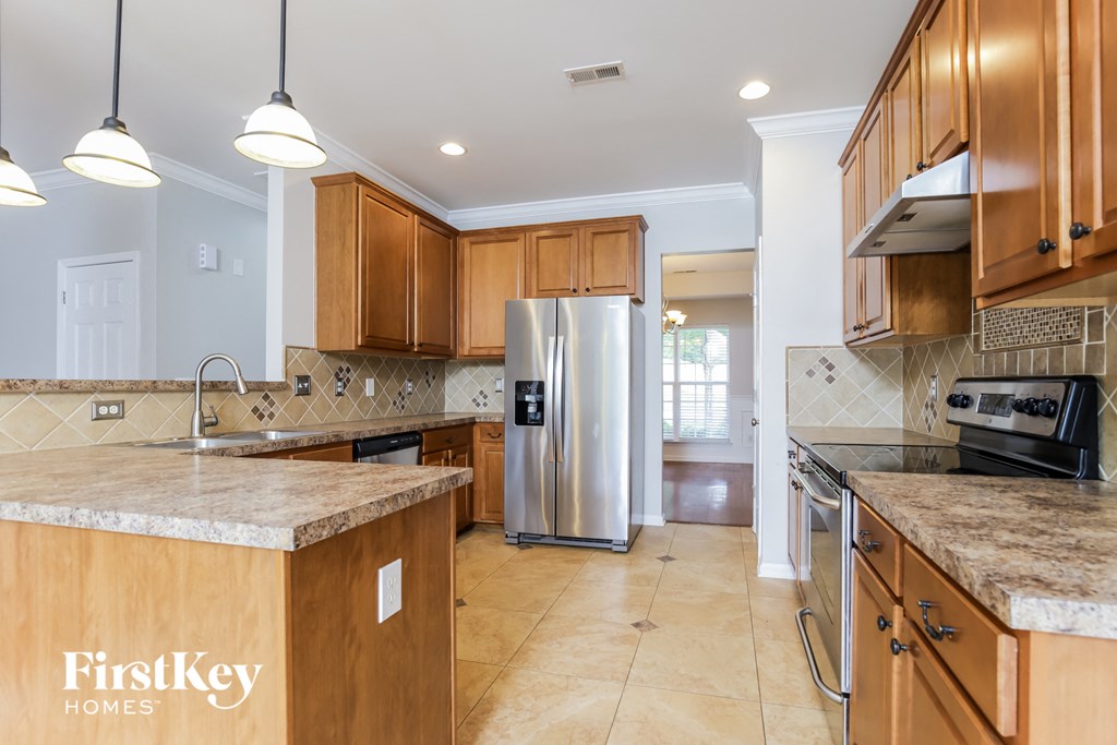 a kitchen with wooden cabinets and a stainless steel refrigerator