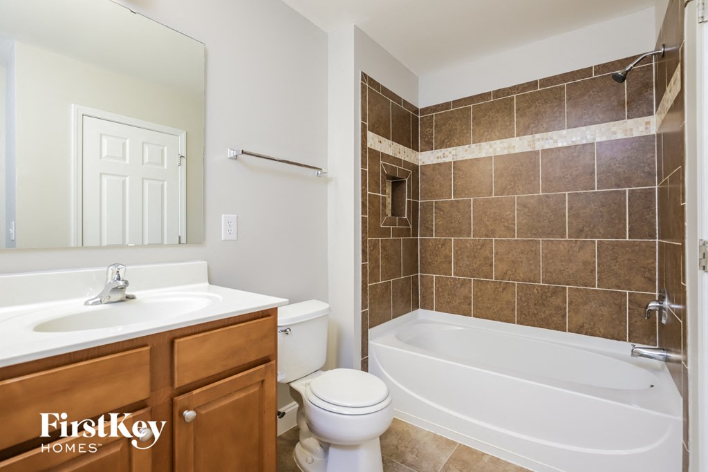a bathroom with a sink toilet and a bath tub