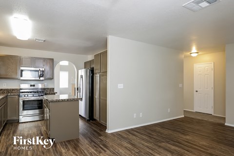 a kitchen with stainless steel appliances and a hard wood floor