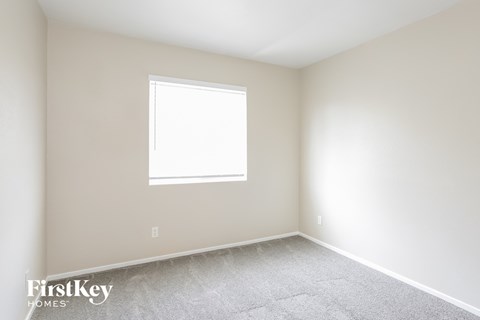 a room with white walls and a window