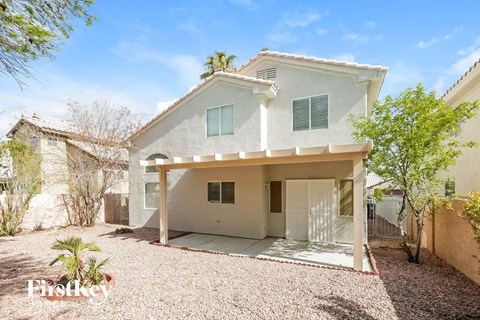 a white house with a driveway and a garage door