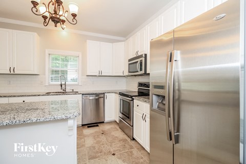 a kitchen with stainless steel appliances and white cabinets