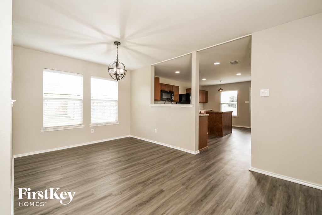 an empty living room and kitchen in a new home