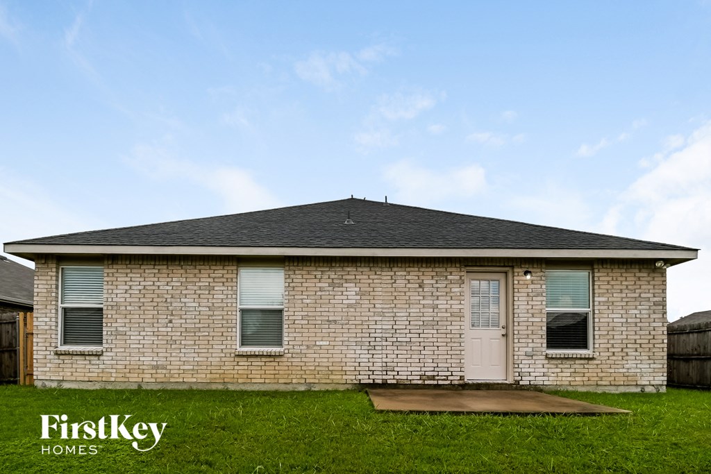 the front of a brick house with a white door