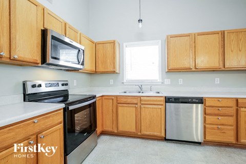 a kitchen with wooden cabinets