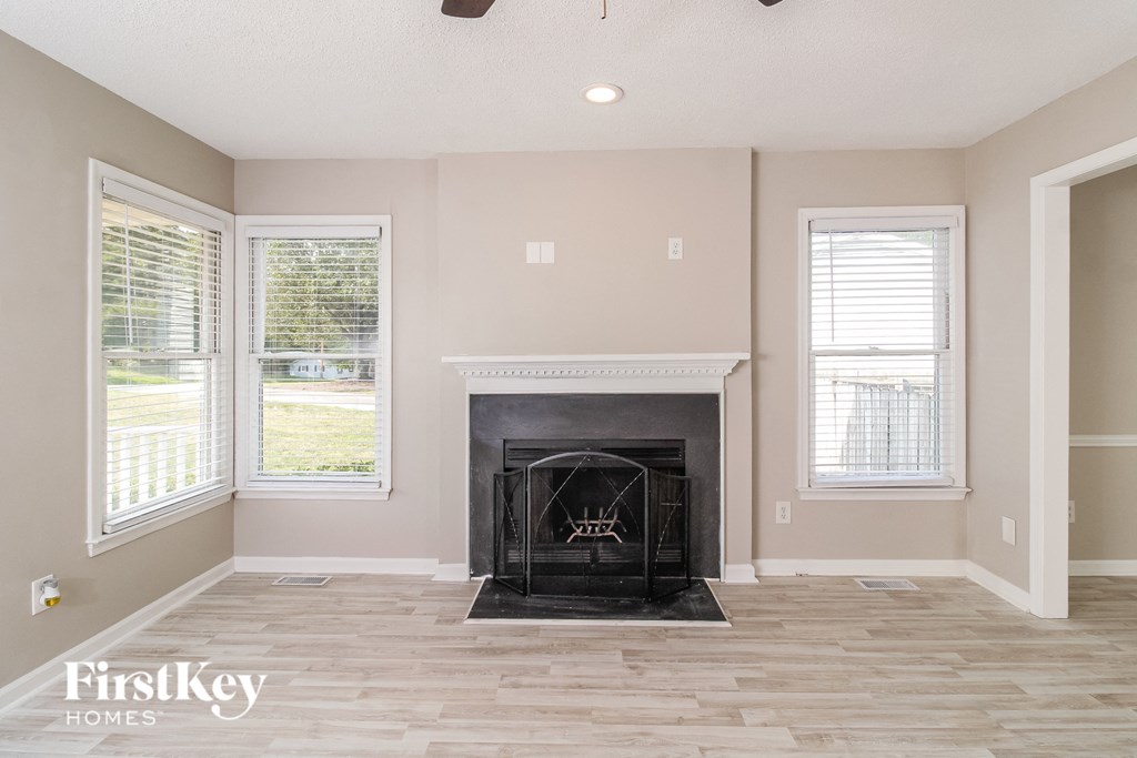 a living room with a fireplace and a wooden floor