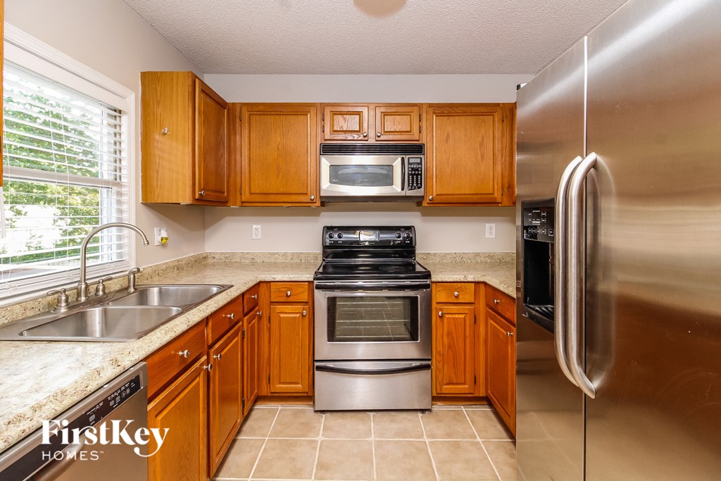 a kitchen with stainless steel appliances and wooden cabinets