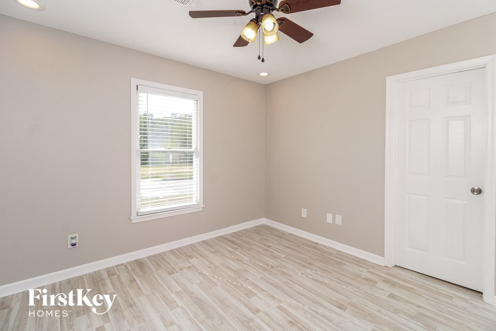 the second bedroom is spacious and has a ceiling fan