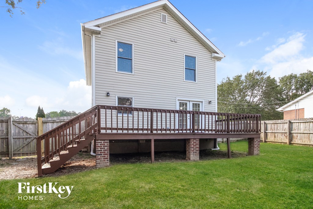 the back of a house with a wooden deck