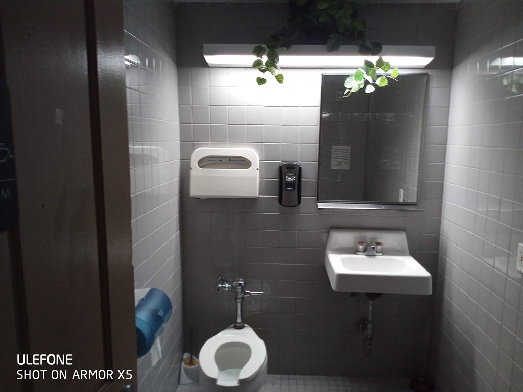 a small bathroom with a toilet sink and a mirror