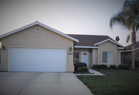 a house with a garage and a palm tree